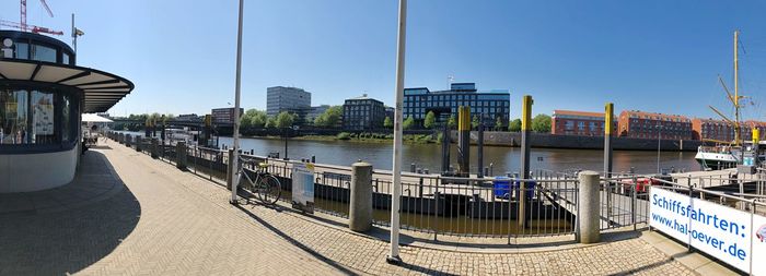 Panoramic view of river and buildings against clear sky