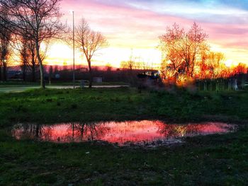 Scenic view of field against sky during sunset