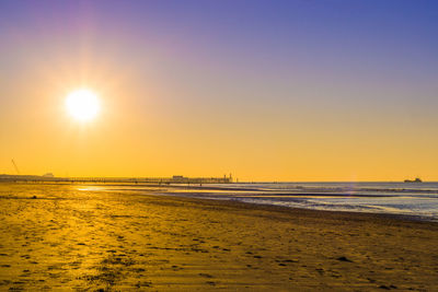 Scenic view of beach against sky during sunset