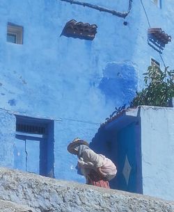 Full length of man on wall of building