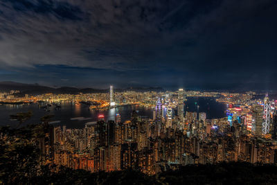 Illuminated cityscape against sky at night