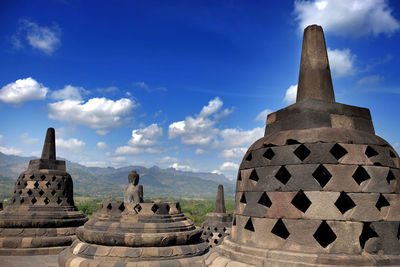 Ruins of temple against cloudy sky