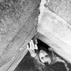 Directly above shot of woman looking up while standing in corner wall