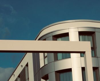 Low angle view of modern building against clear blue sky