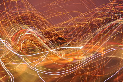 Close-up of light trails against sky at night