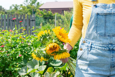 Woman holding yellow flowers