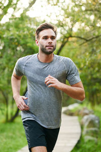 Man jogging against trees