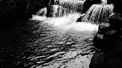 Scenic view of waterfall in sea