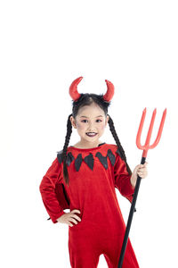 Portrait of smiling girl standing against white background