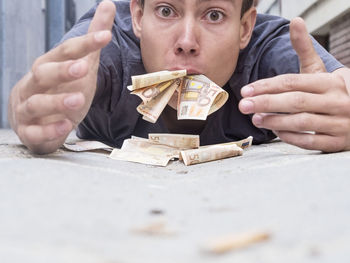 Portrait of man eating money