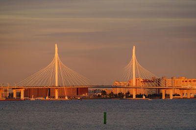 Bridge over river against sky during sunset