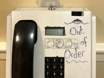 Close-up of telephone booth on table