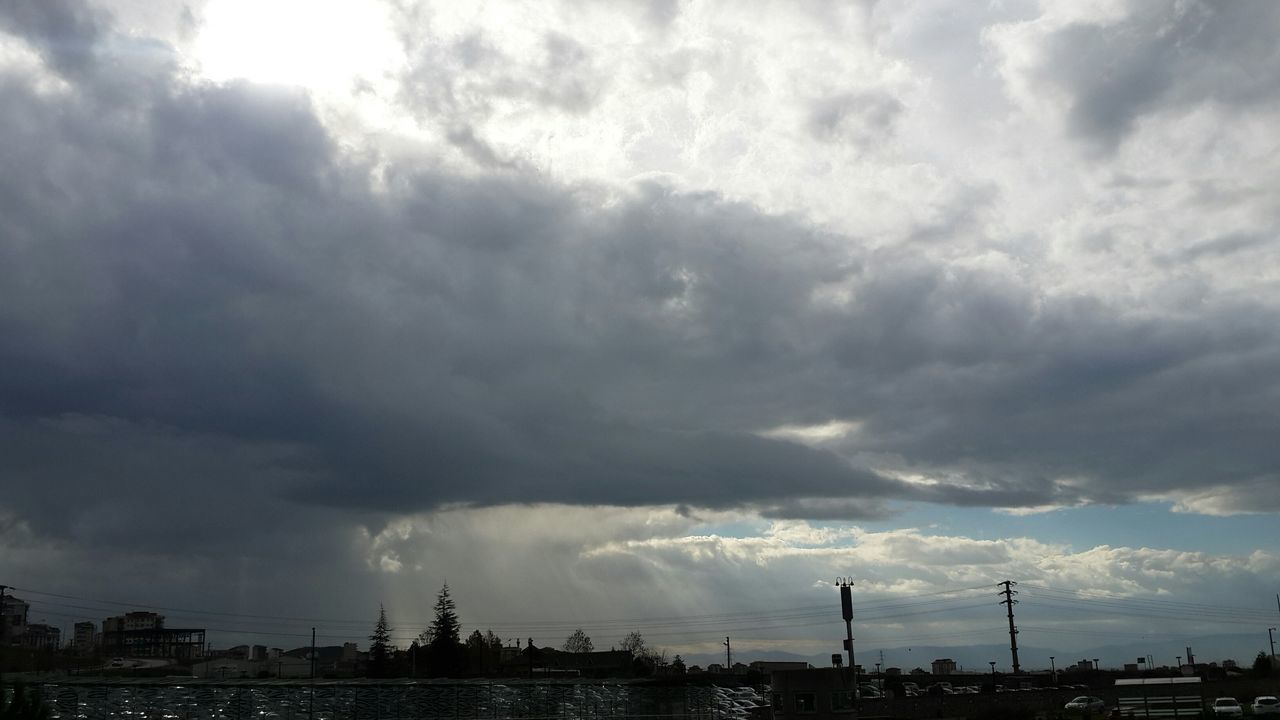 sky, cloud - sky, cloudy, weather, silhouette, overcast, cloud, low angle view, cloudscape, nature, storm cloud, beauty in nature, tranquility, scenics, built structure, dramatic sky, tranquil scene, sunbeam, outdoors, no people