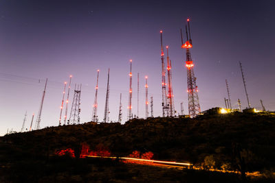 Illuminated buildings against sky at night