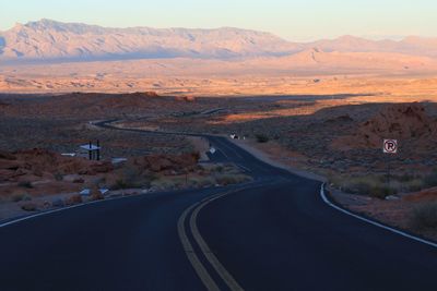 Empty road leading towards mountains at valley of fire state park