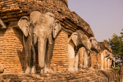 Low angle view of elephant statue against sky