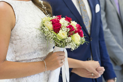 Close-up of woman holding bouquet of roses