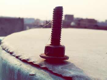 Close-up of rusty metal against sky