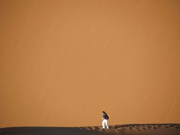 Woman walking on sand at desert