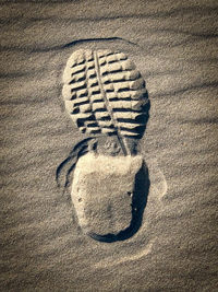 High angle view of footprints on sand