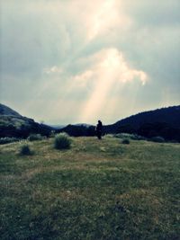 Man standing on field against sky