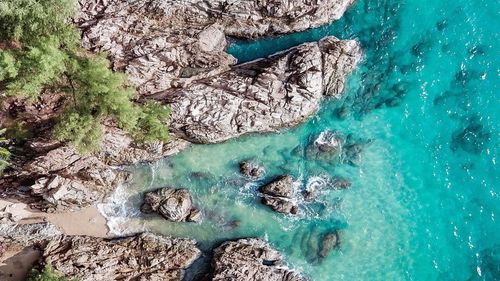 High angle view of rocks by sea