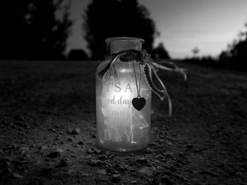 Close-up of drink in jar on field