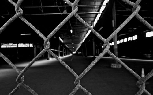 Close-up of chainlink fence in parking lot