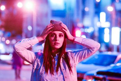 Portrait of young woman in city