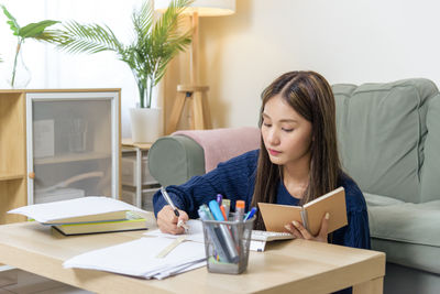Young woman using laptop at home