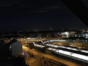 High angle view of illuminated cityscape against sky at night