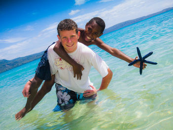 Portrait of smiling young man in sea