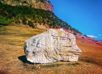 Rock formation on land against sky