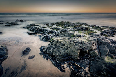 Scenic view of sea against sky at sunset