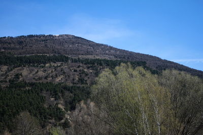 Scenic view of mountains against blue sky