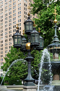 Fountain against building in city