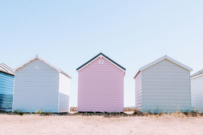 Beach huts against clear sky