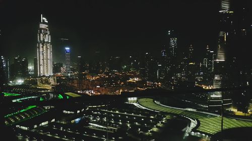 Aerial view of illuminated buildings in city at night