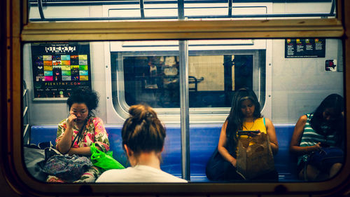 Rear view of people sitting in train