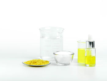 Glasses of drink against white background
