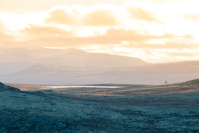 Scenic view of landscape against sky during sunset