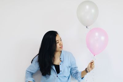Woman looking at balloons