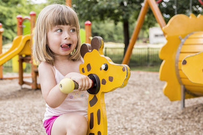 Portrait of cute girl playing in playground