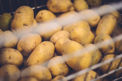 High angle view of potatoes in metal basket