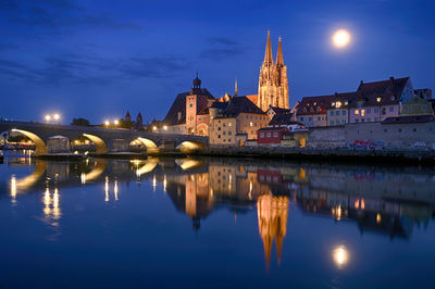 Reflection of illuminated buildings in city