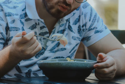 Midsection of man preparing food