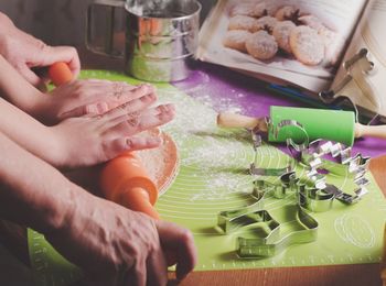 Close-up of hands rolling dough