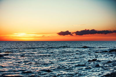 Scenic view of sea against romantic sky at sunset