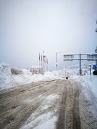 Scenic view of snow covered beach against clear sky