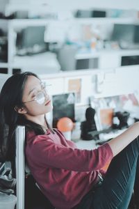 Young woman sleeping on chair at home